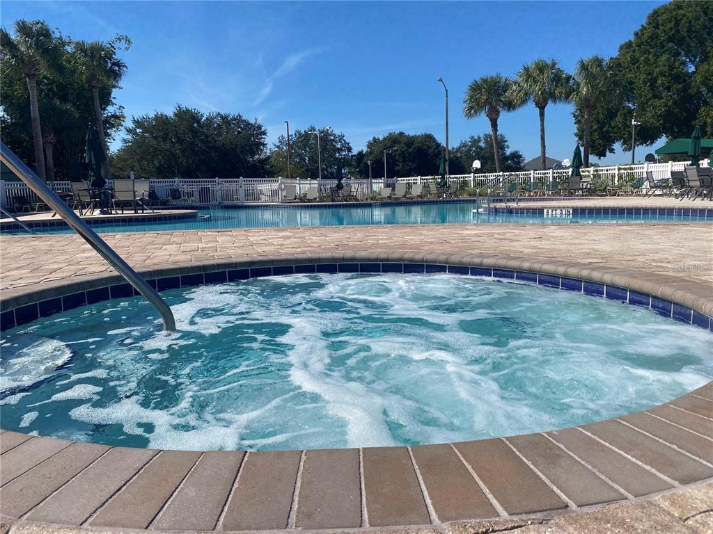 4824 Woodmere Road Land O Lakes, FL 34639 - Photo 47 of 50 a view of a swimming pool with a lounge chairs