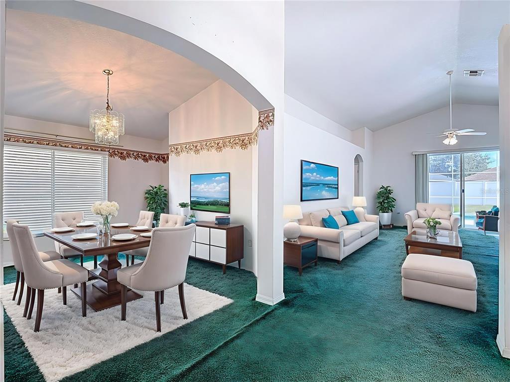 4824 Woodmere Road Land O Lakes, FL 34639 - Photo 5 of 50 a living room with furniture and a chandelier