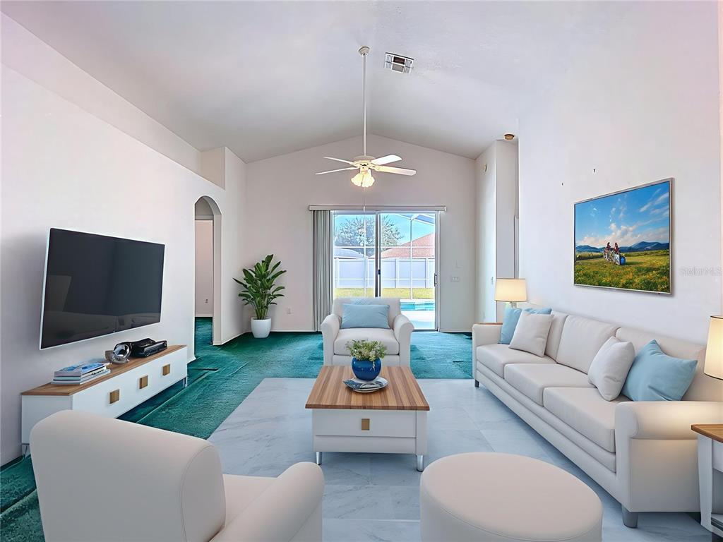 4824 Woodmere Road Land O Lakes, FL 34639 - Photo 7 of 50 a living room with furniture and a flat screen tv