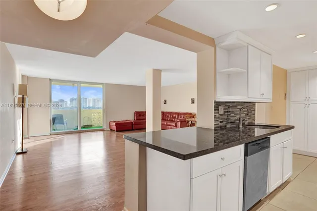 a kitchen with stainless steel appliances granite countertop a stove microwave and sink