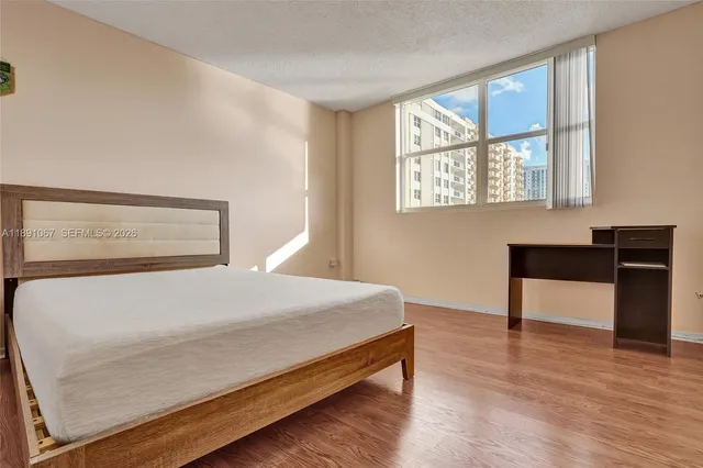 a bedroom with a bed and a cabinet