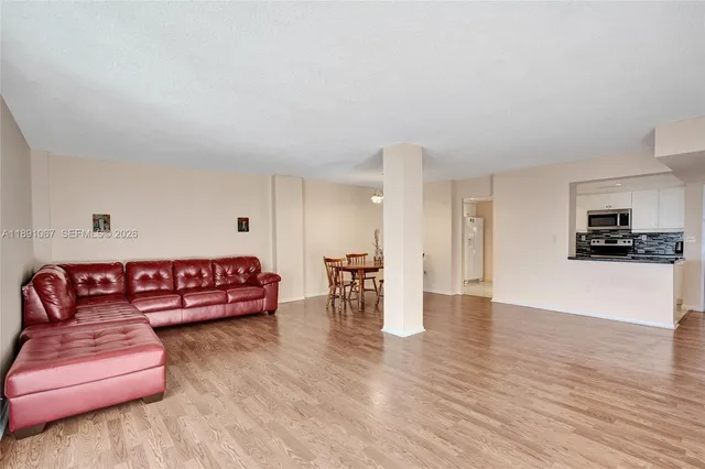 a living room with furniture window and wooden floor