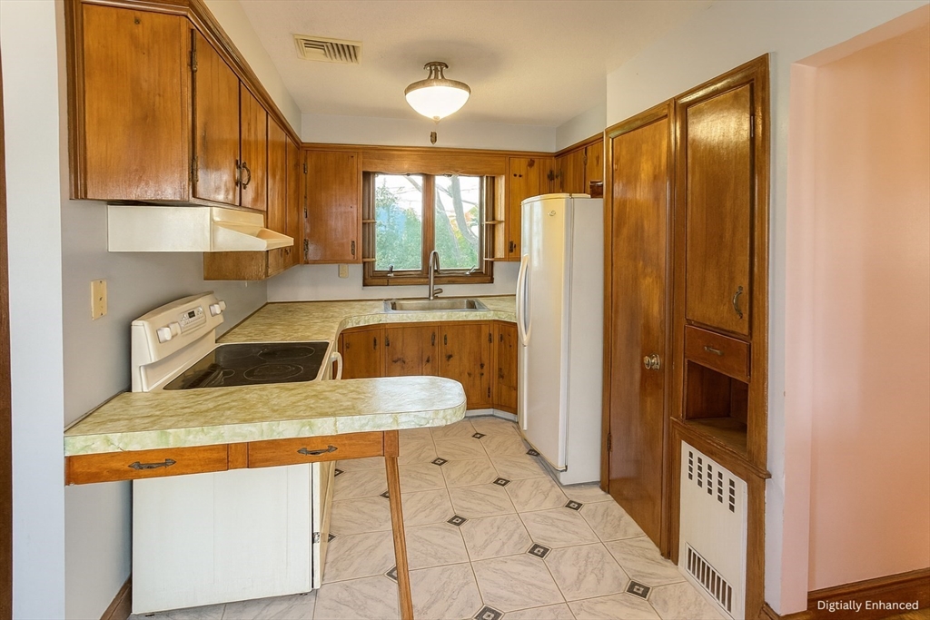 498 Tower Street Fall River, MA 02721 - Photo 6 of 8 a kitchen with stainless steel appliances granite countertop a sink a stove and refrigerator