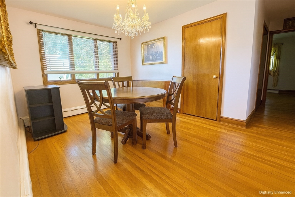 498 Tower Street Fall River, MA 02721 - Photo 7 of 8 a view of a dining room with furniture and wooden floor