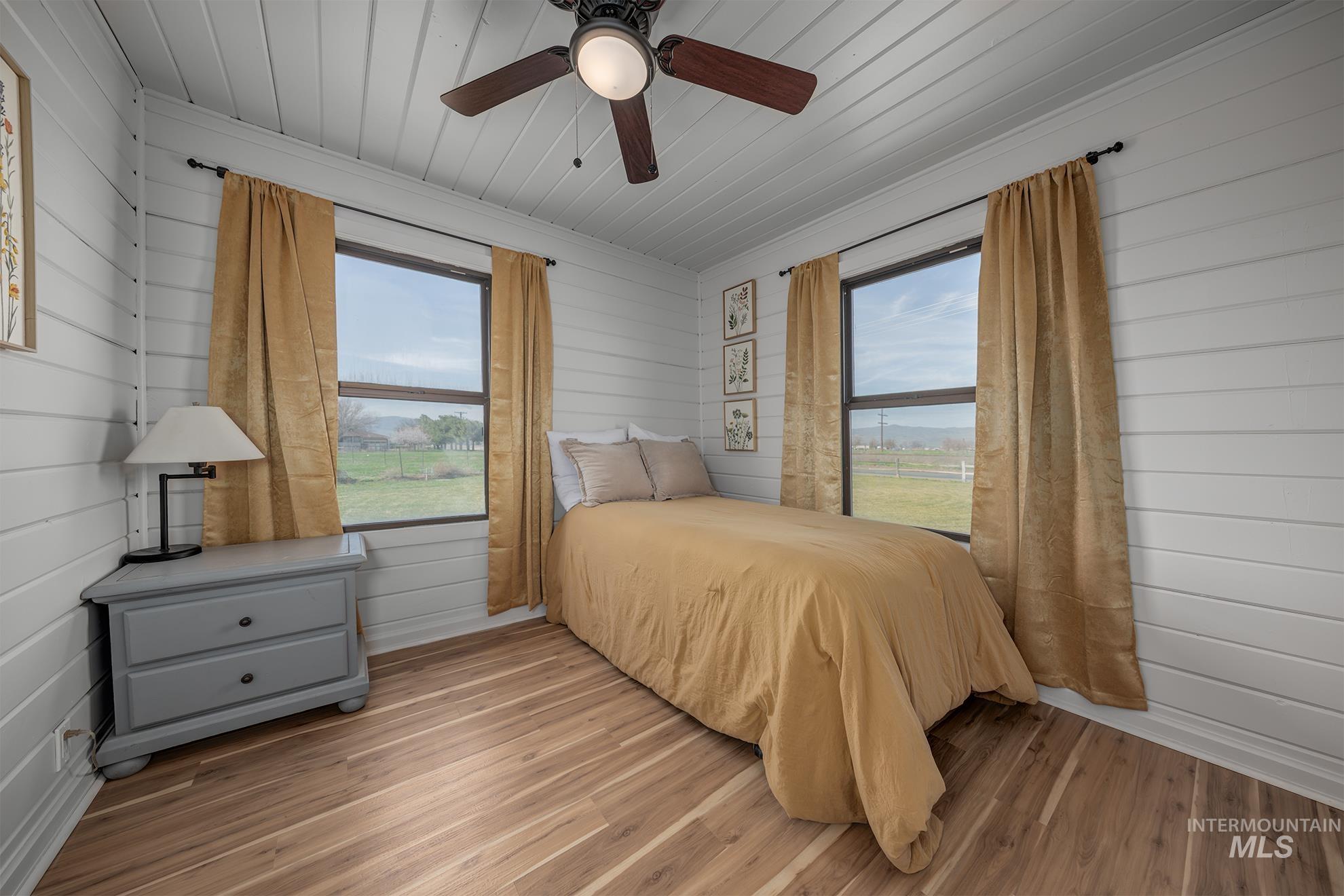 1009 County Road 70 Weiser, ID 83672 - Photo 10 of 48 Bedroom with wood walls, wood finished floors, ceiling fan, and wood ceiling