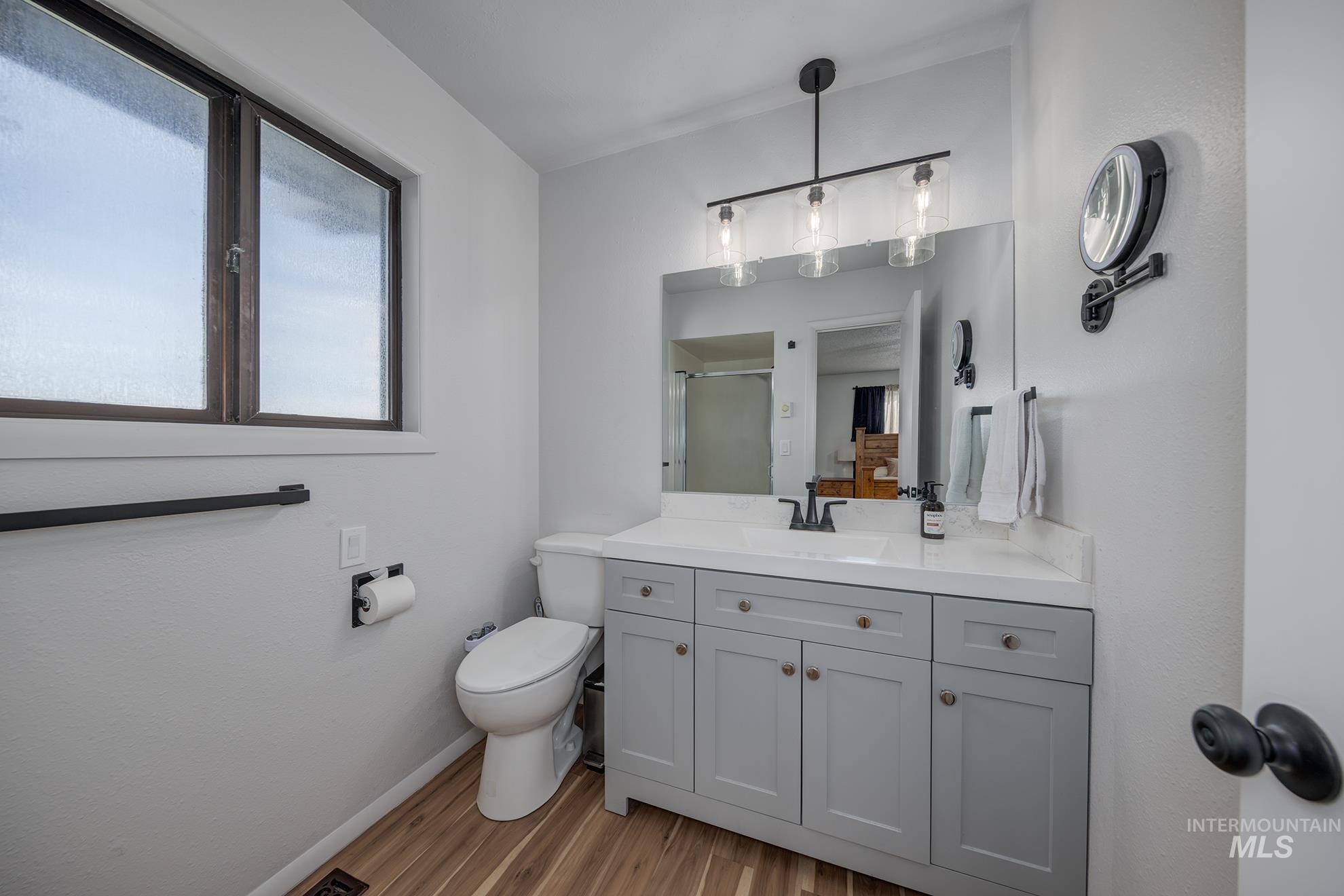 1009 County Road 70 Weiser, ID 83672 - Photo 16 of 48 Bathroom featuring vanity, a shower stall, and light wood-type flooring