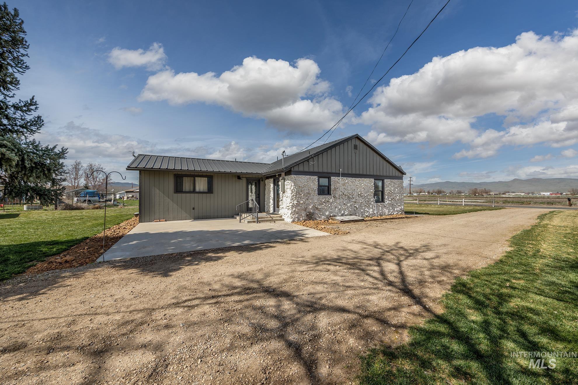 1009 County Road 70 Weiser, ID 83672 - Photo 47 of 48 Rear view of house featuring a metal roof and driveway