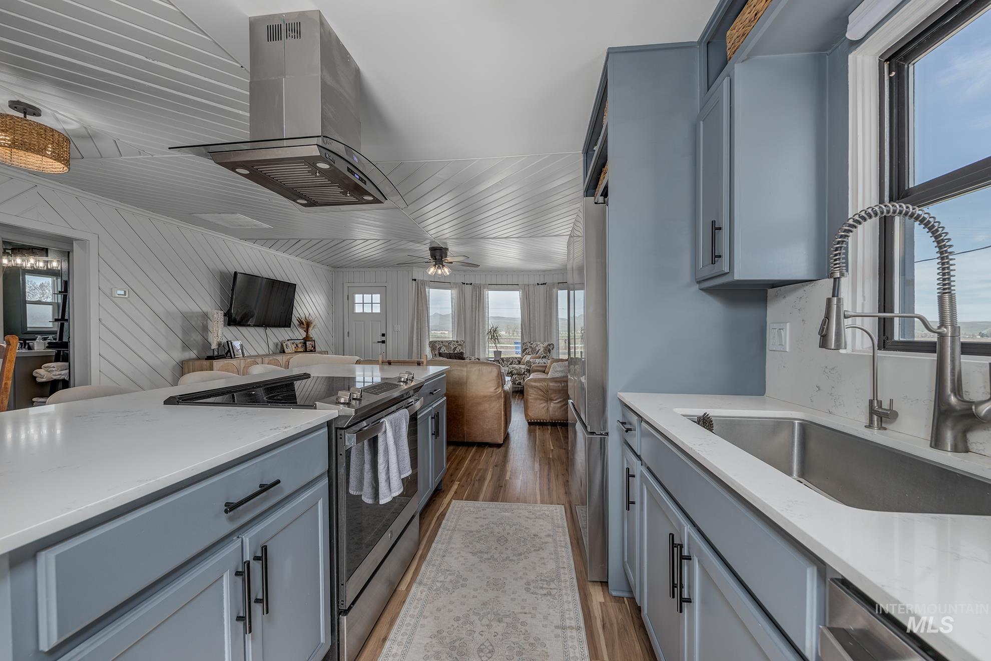 1009 County Road 70 Weiser, ID 83672 - Photo 48 of 48 Kitchen featuring island exhaust hood, open floor plan, stainless steel appliances, and plenty of natural light