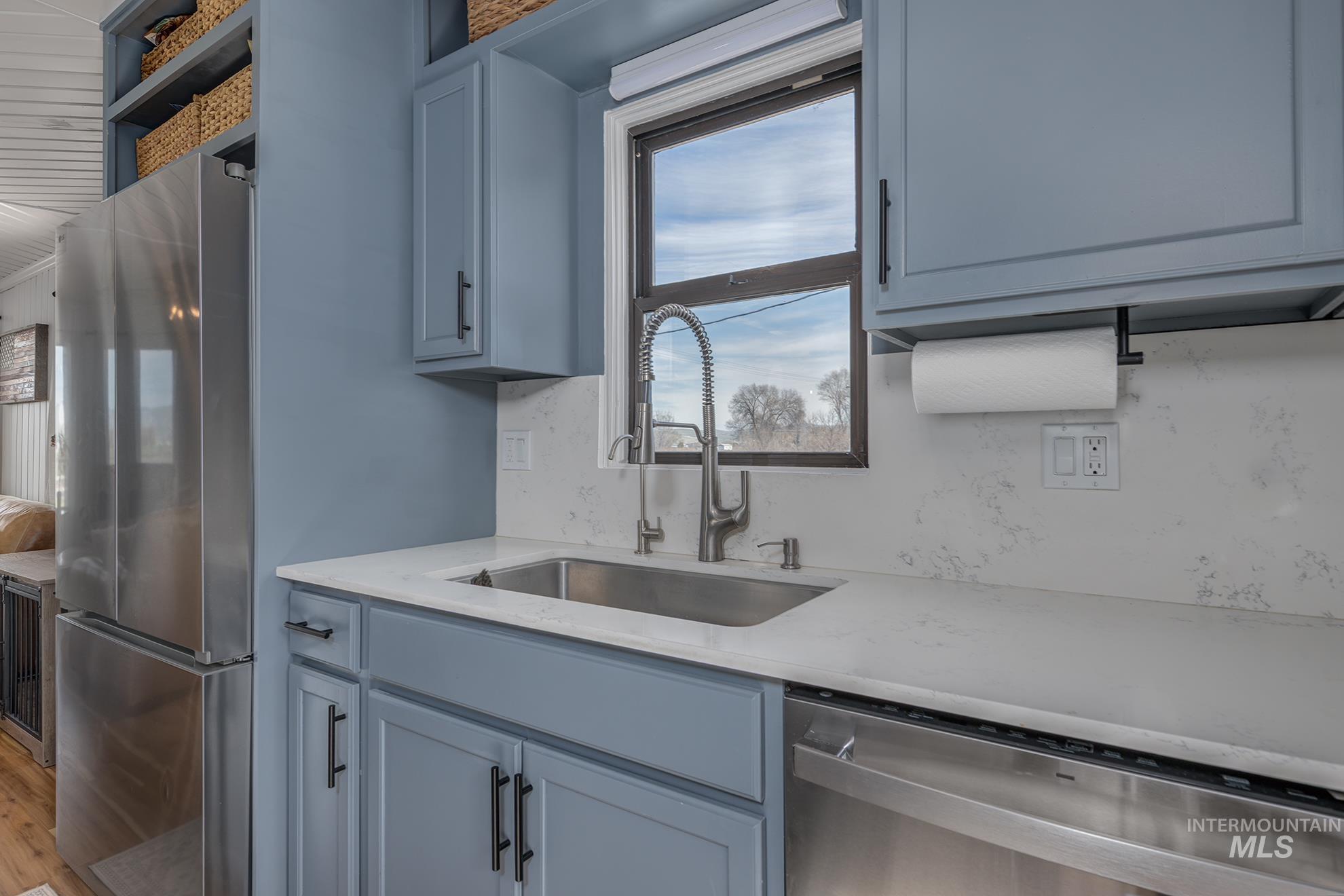 1009 County Road 70 Weiser, ID 83672 - Photo 9 of 48 Kitchen featuring stainless steel appliances, light stone counters, and light wood finished floors