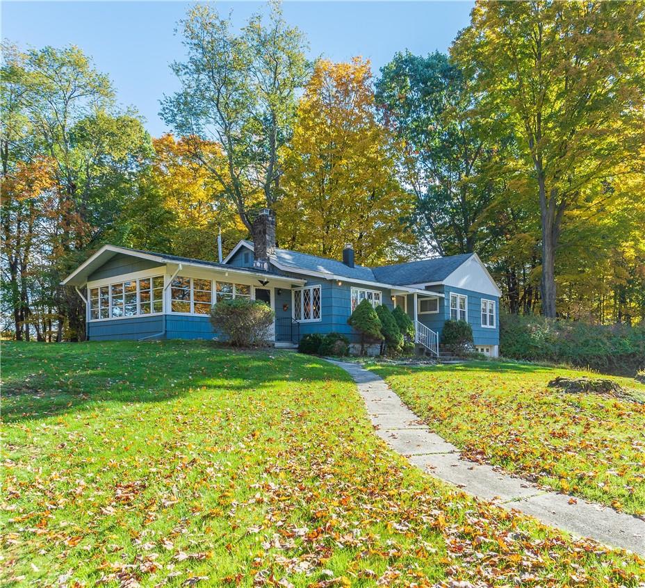 a front view of a house with a garden