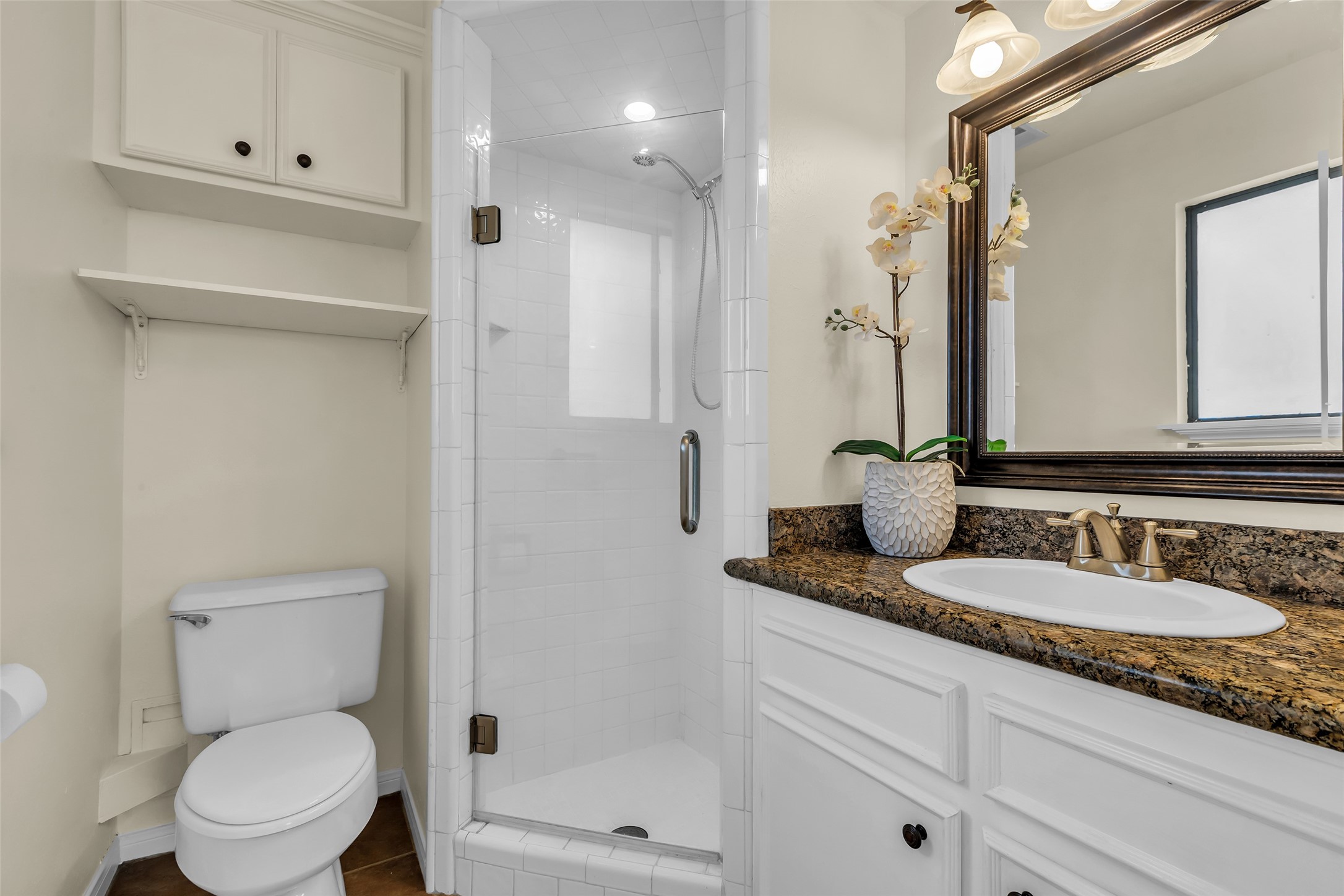 17831 West Fm 1097 Montgomery, TX 77356 - Photo 22 of 28 a bathroom with a granite countertop toilet sink and mirror