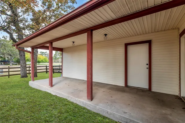 a view of a backyard with wooden fence and floor