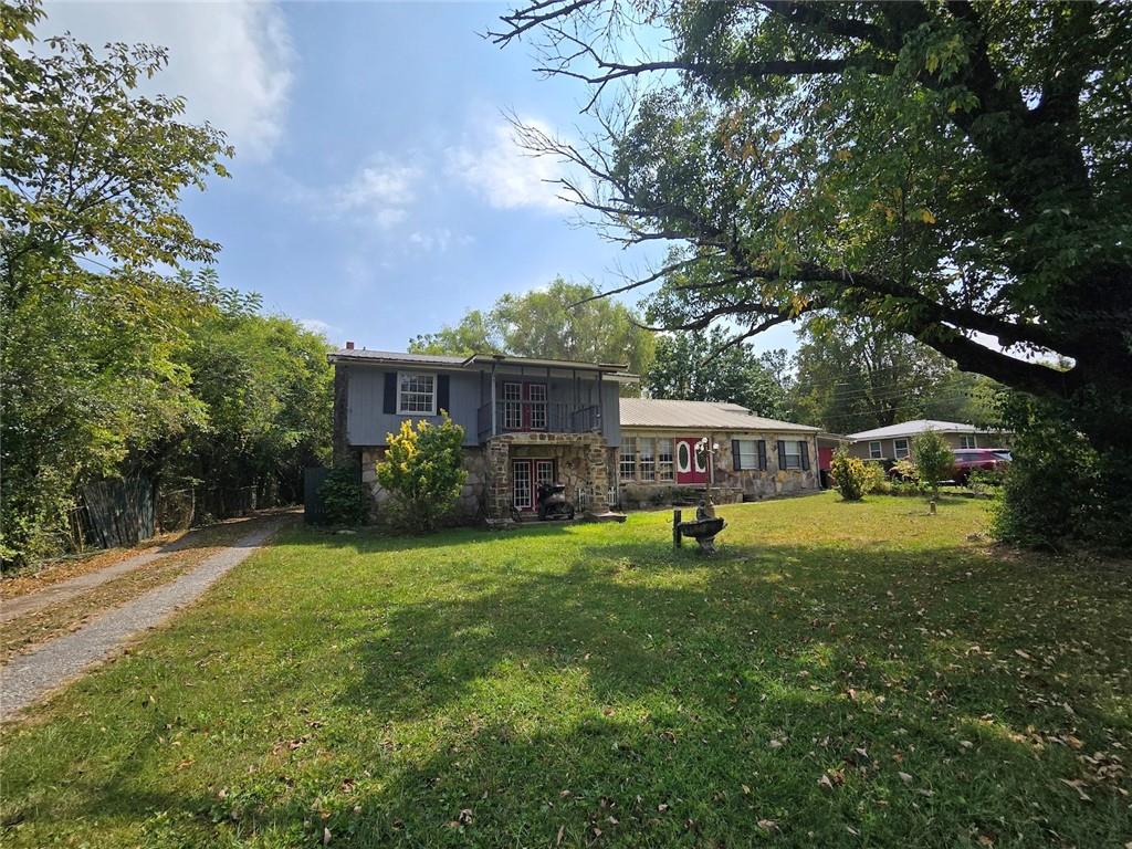 a view of an house with backyard space and garden