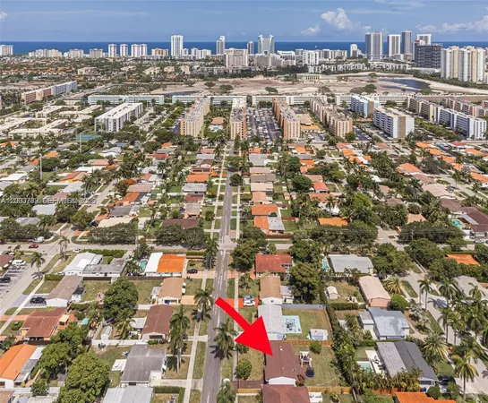 an aerial view of residential houses with city view