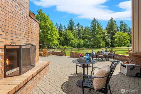 a patio with water view fountain and outdoor seating