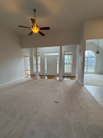 a view of a livingroom with a ceiling fan and window