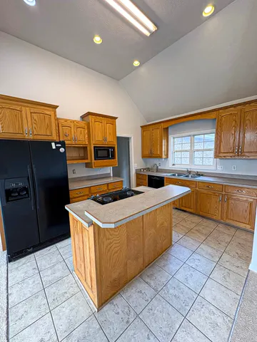 a kitchen with stainless steel appliances granite countertop a stove a sink and a refrigerator