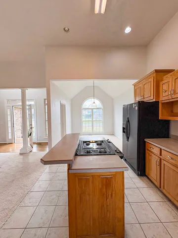 a kitchen with a stove a sink dishwasher and a refrigerator