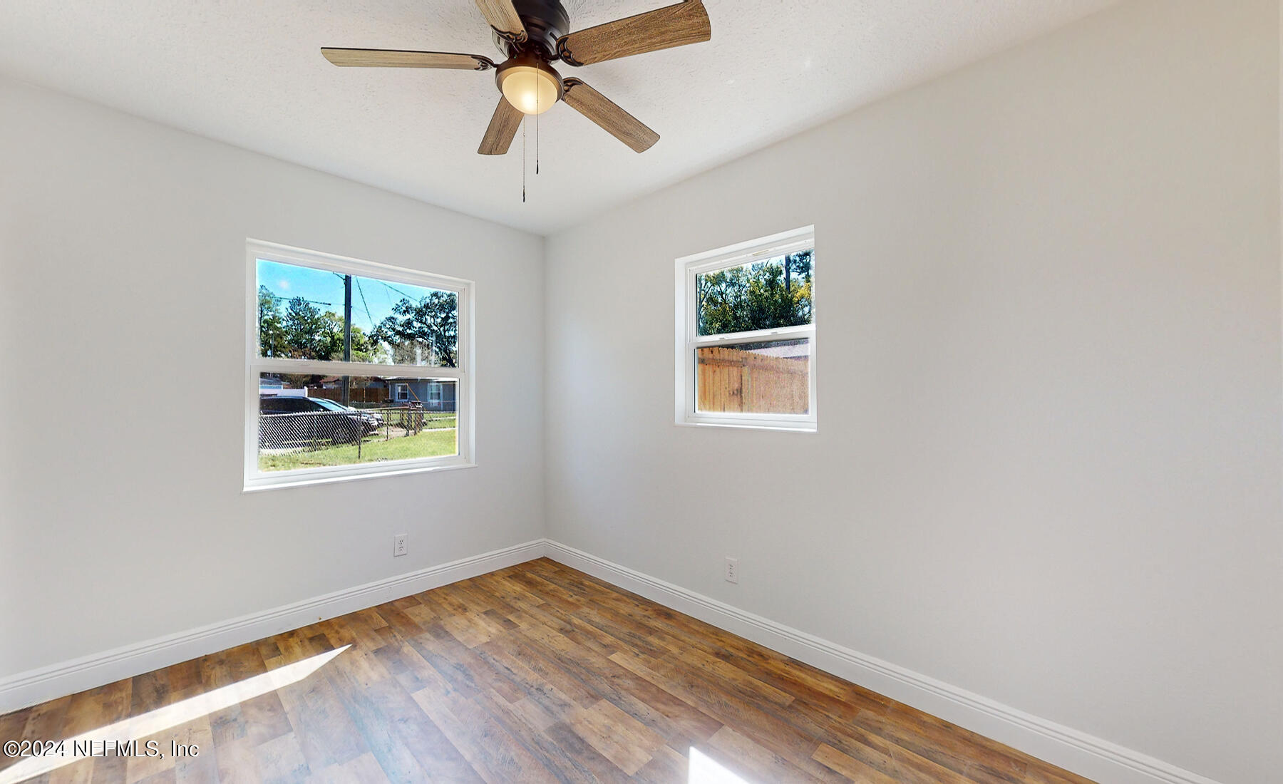 2136 Azore Court Jacksonville, FL 32216 - Photo 11 of 36 a view of empty room with wooden floor and fan