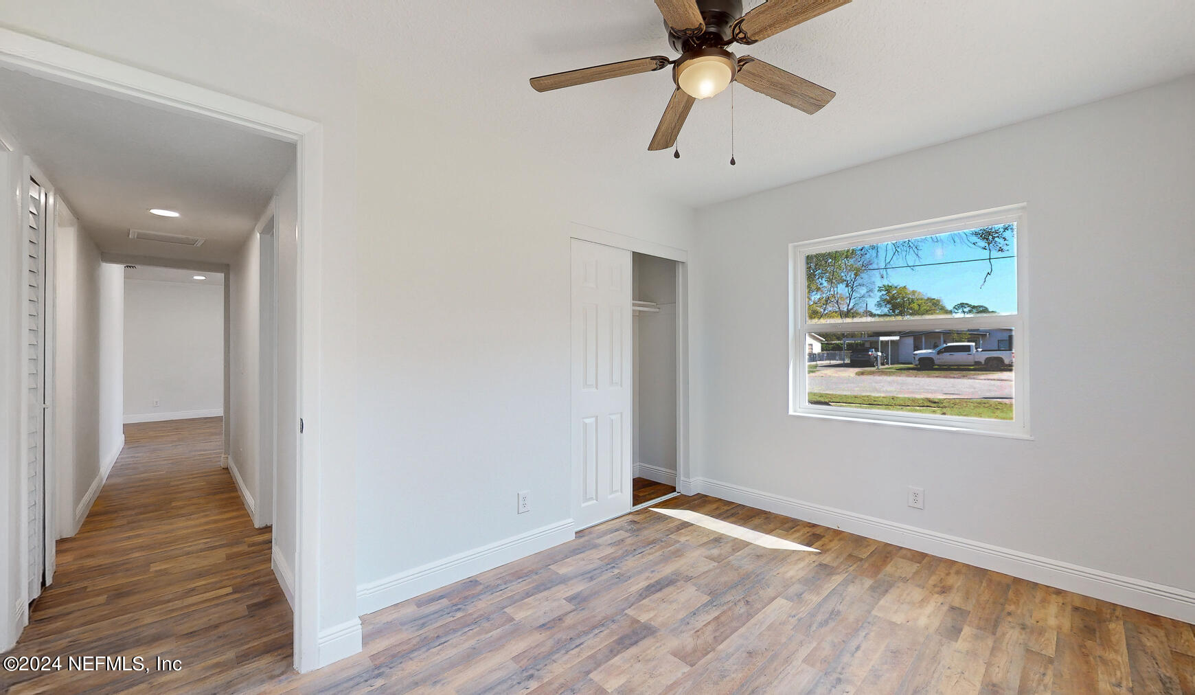 2136 Azore Court Jacksonville, FL 32216 - Photo 12 of 36 a view of an empty room with window and wooden floor