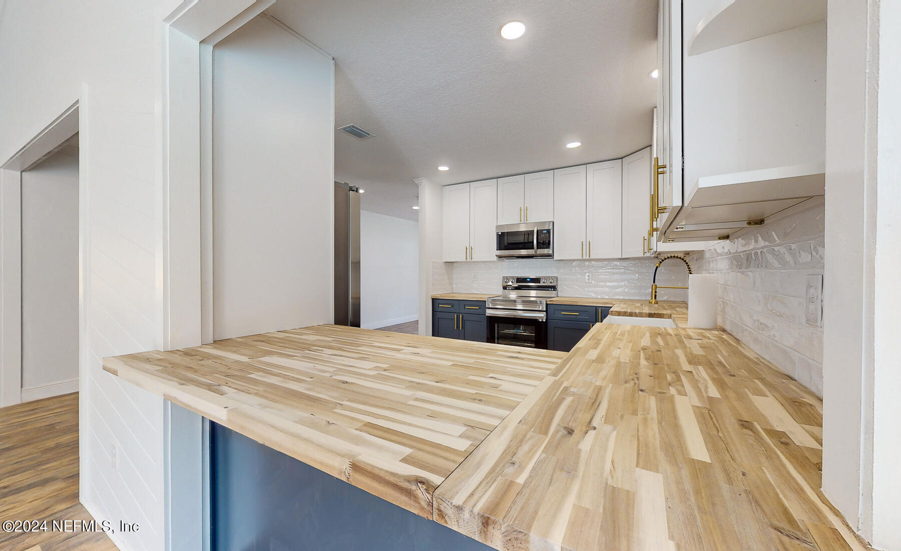 2136 Azore Court Jacksonville, FL 32216 - Photo 15 of 36 a kitchen with granite countertop a sink stainless steel appliances and cabinets