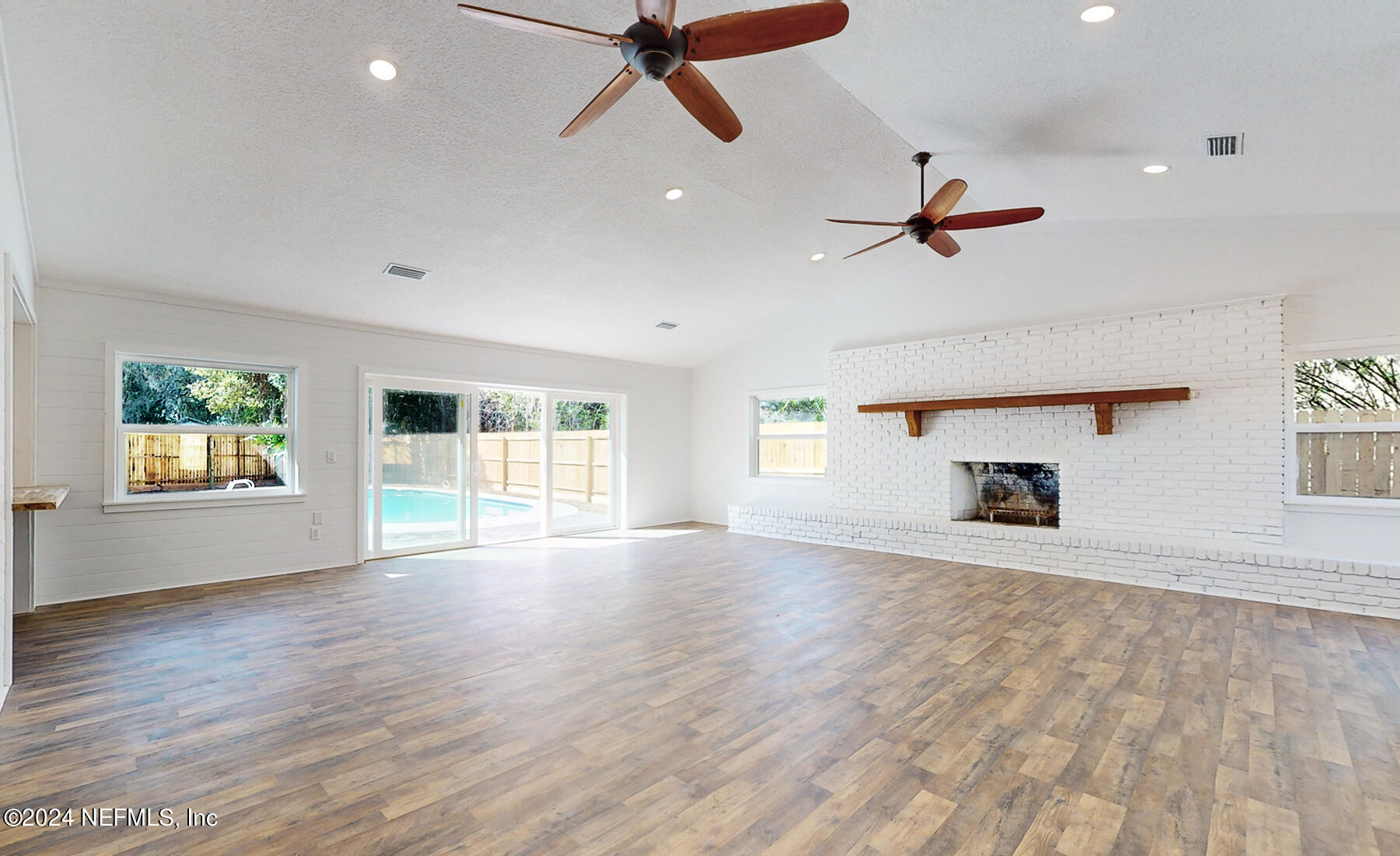 2136 Azore Court Jacksonville, FL 32216 - Photo 16 of 36 an empty room with windows and ceiling fan