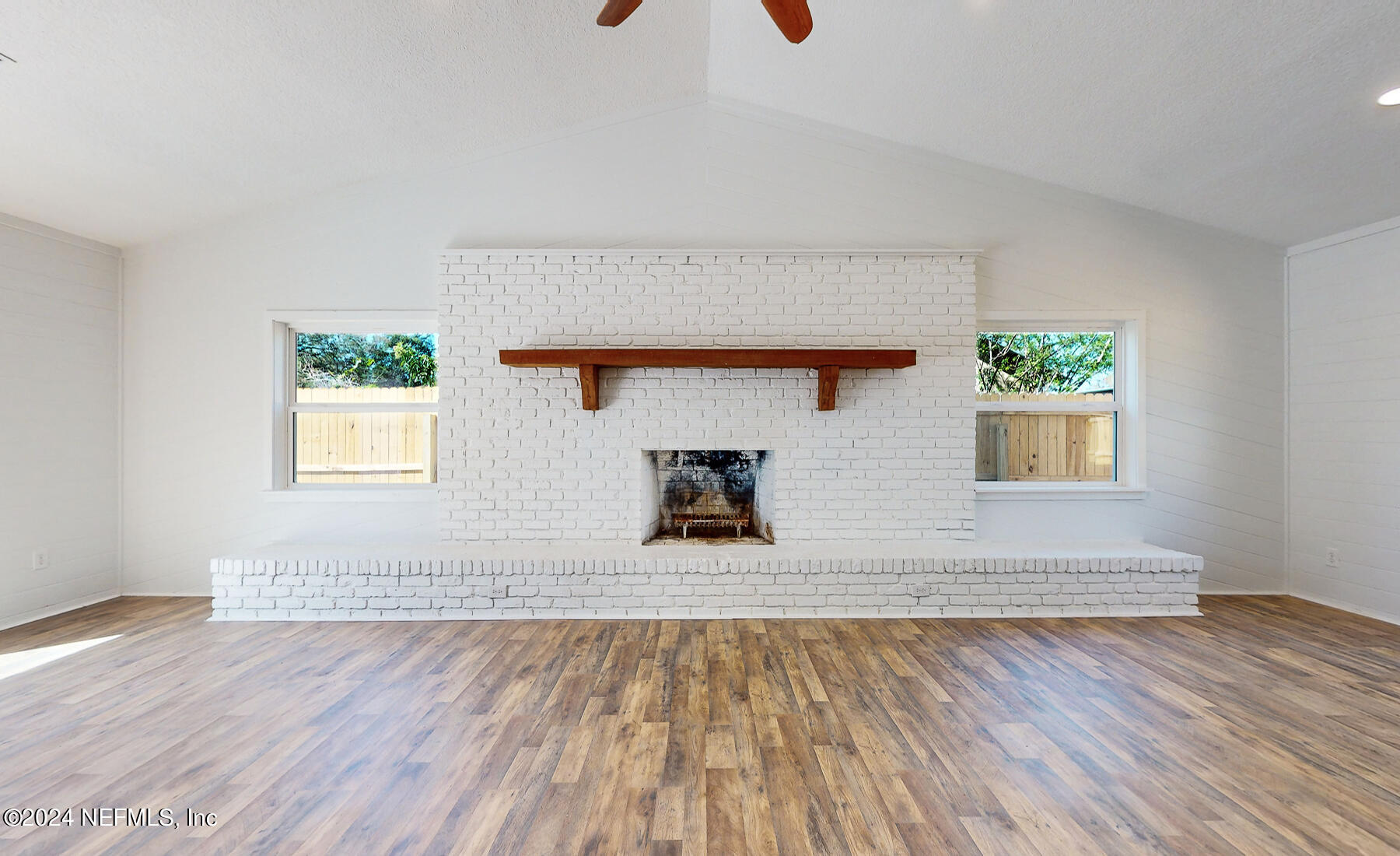 2136 Azore Court Jacksonville, FL 32216 - Photo 19 of 36 a view of an empty room with wooden floor and a window