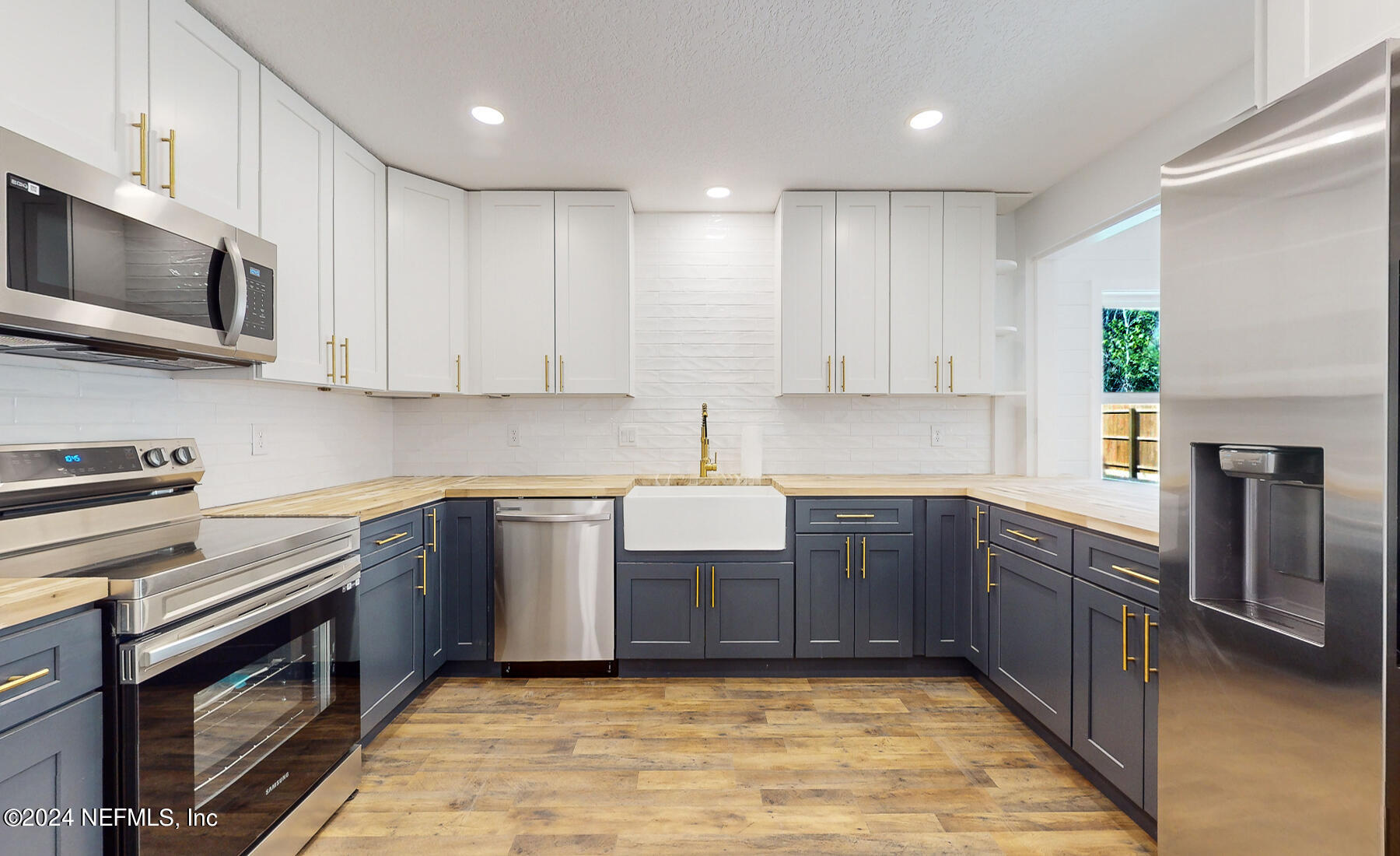 2136 Azore Court Jacksonville, FL 32216 - Photo 21 of 36 a kitchen with stainless steel appliances granite countertop wooden cabinets a stove top oven a sink and dishwasher