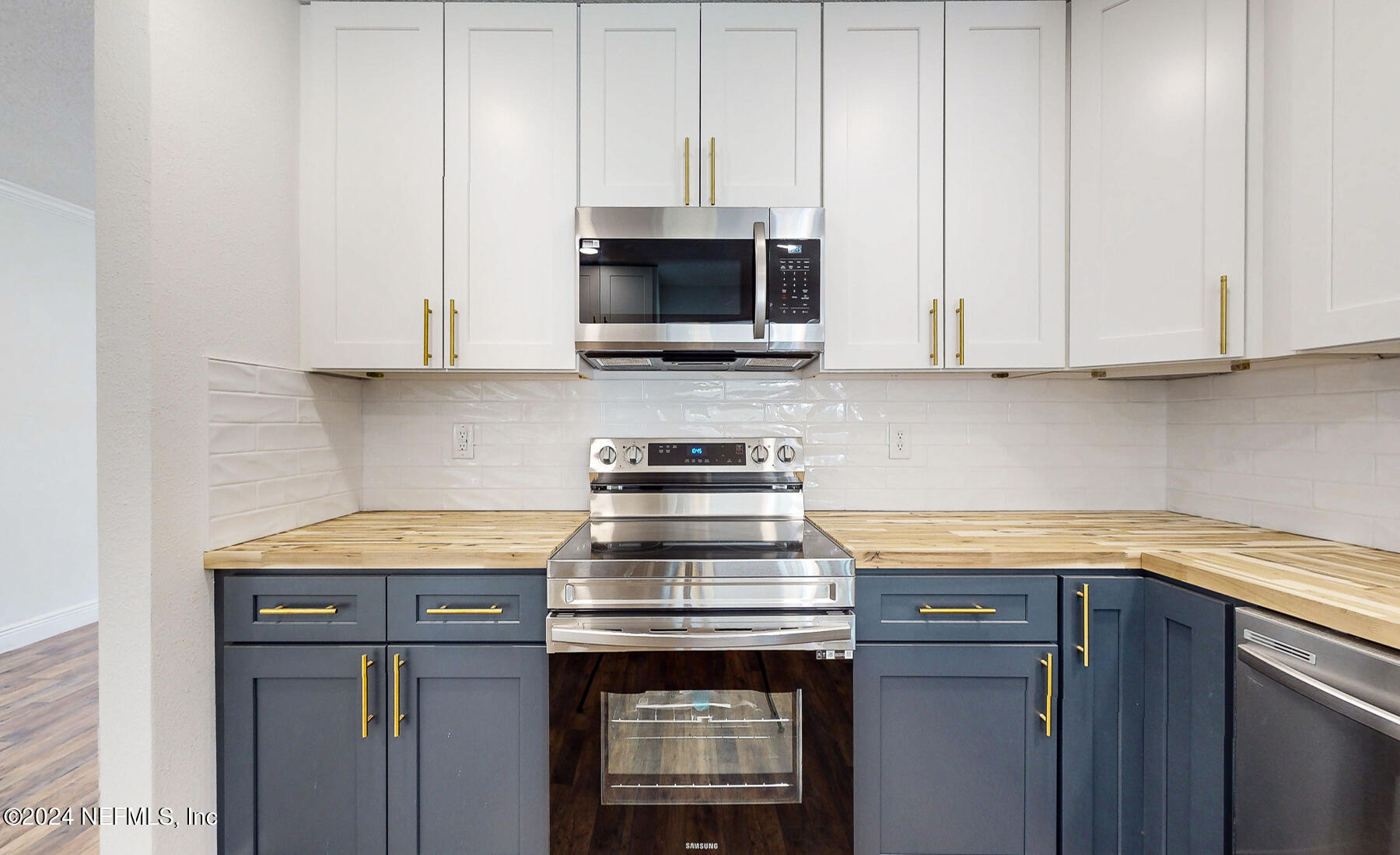 2136 Azore Court Jacksonville, FL 32216 - Photo 22 of 36 a kitchen with stainless steel appliances granite countertop white cabinets and a stove top oven