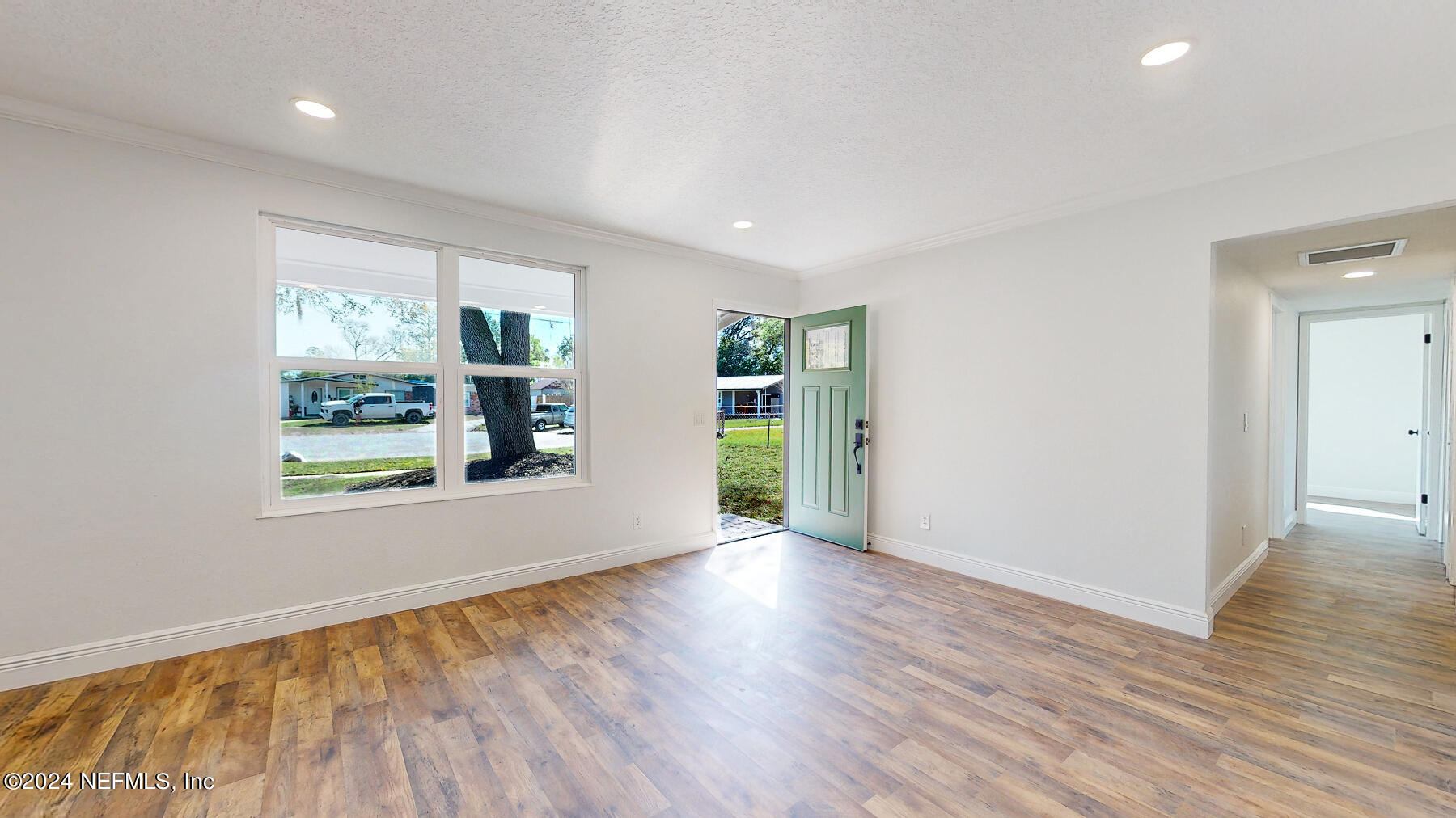 2136 Azore Court Jacksonville, FL 32216 - Photo 26 of 36 an empty room with wooden floor and a window