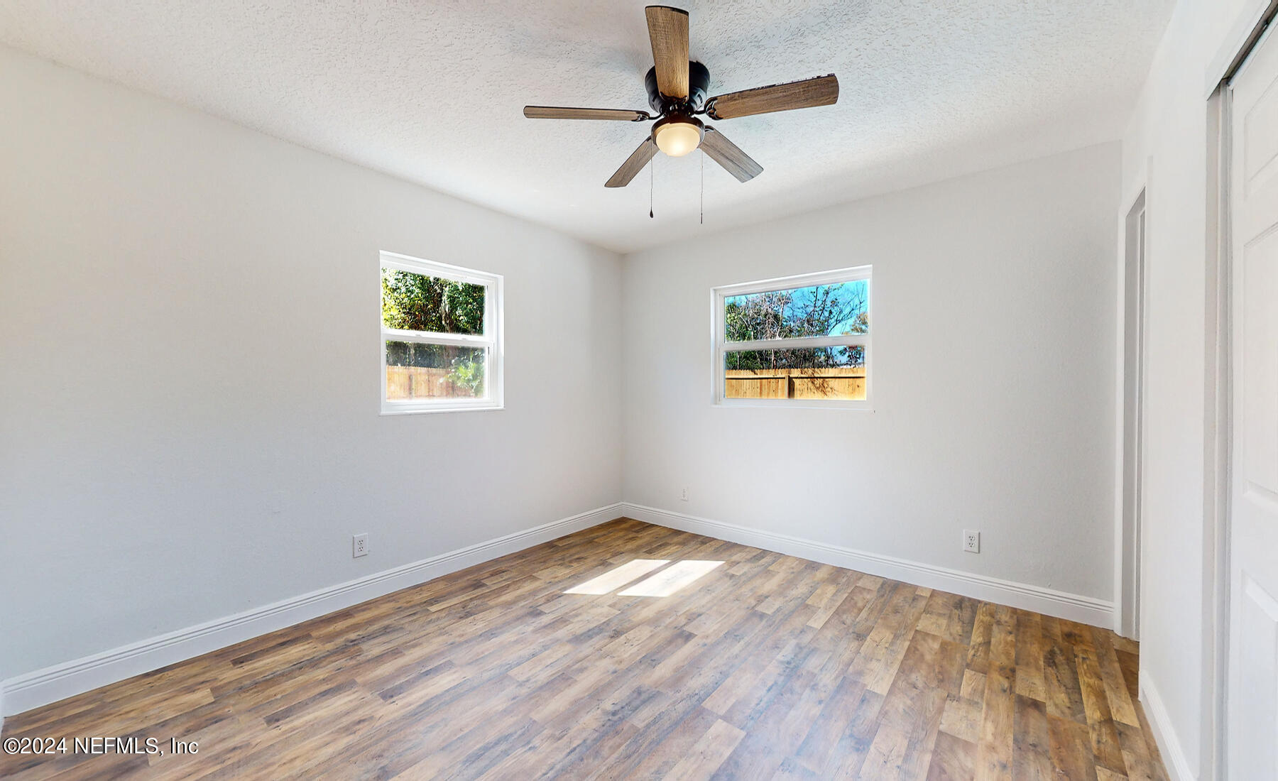 2136 Azore Court Jacksonville, FL 32216 - Photo 7 of 36 a view of empty room with wooden floor and fan