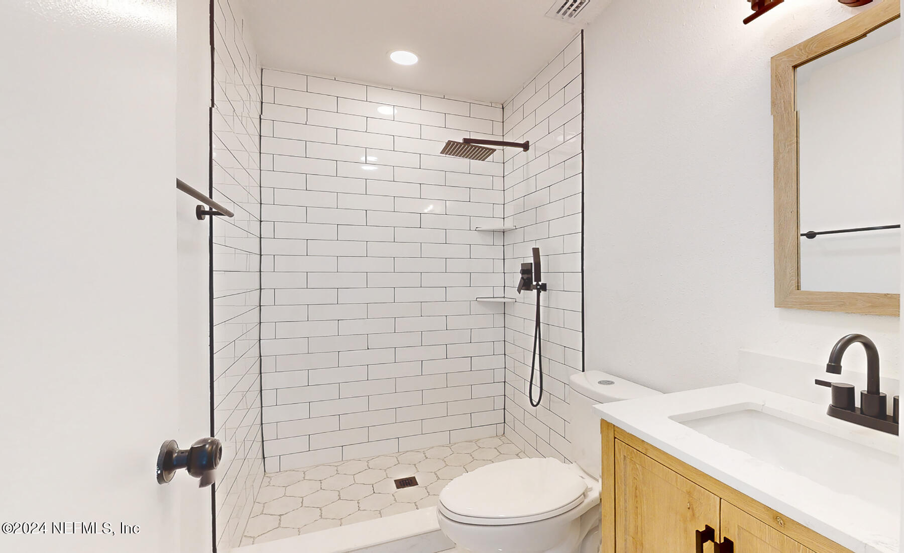 2136 Azore Court Jacksonville, FL 32216 - Photo 9 of 36 a bathroom with a sink a toilet and shower