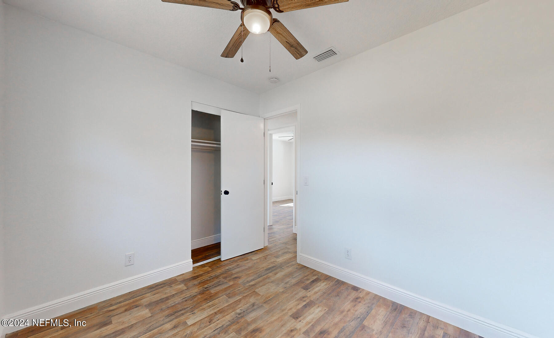 2136 Azore Court Jacksonville, FL 32216 - Photo 10 of 36 a view of empty room with wooden floor and ceiling fan