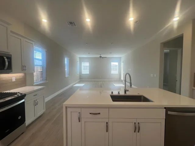 a kitchen with a sink and cabinets