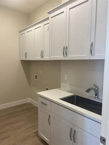 a view of white cabinets and sink