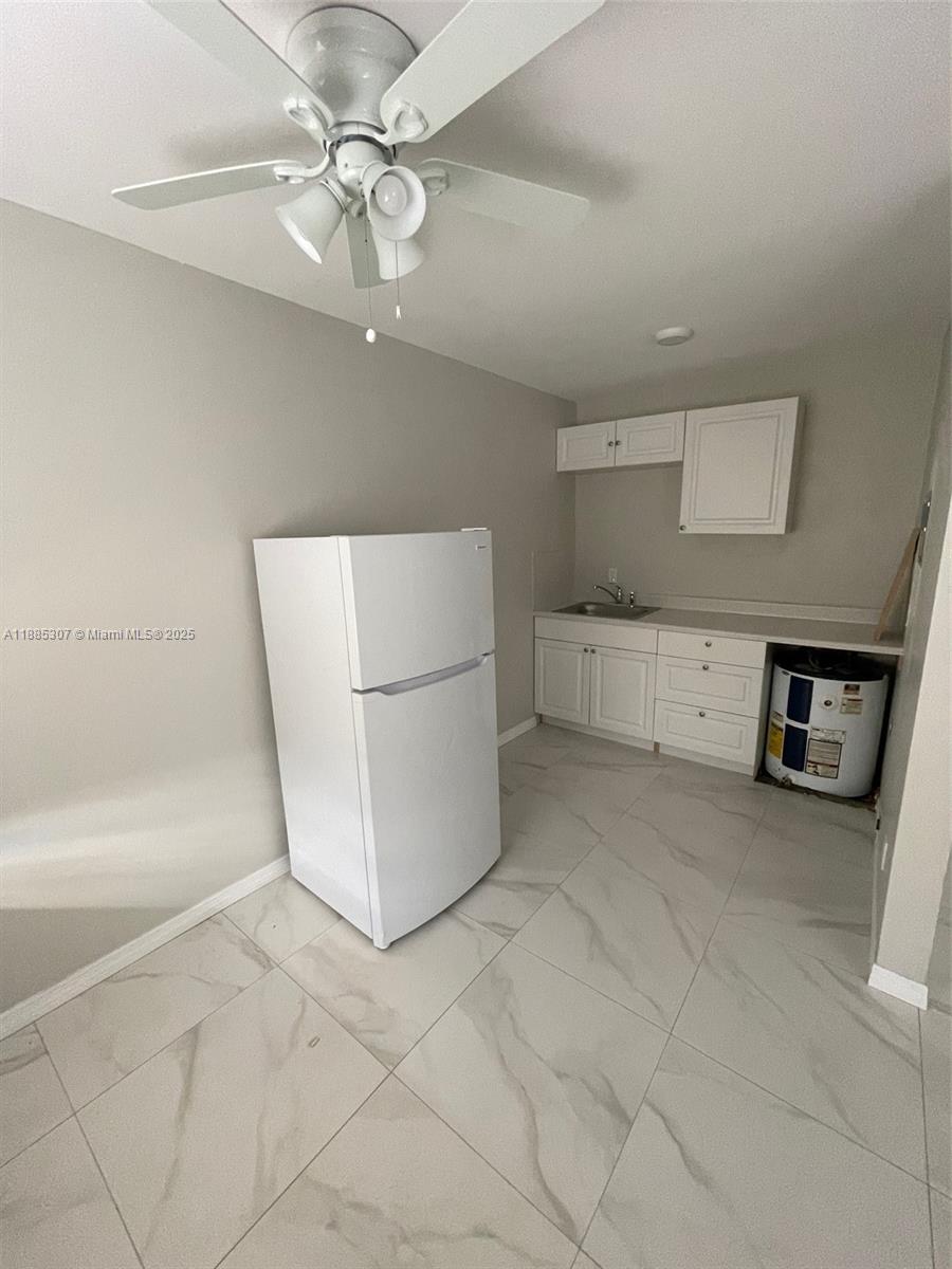 1102 South K Street, Unit 8 Lake Worth, FL 33460 - Photo 2 of 4 a view of a storage & utility room with washer and dryer