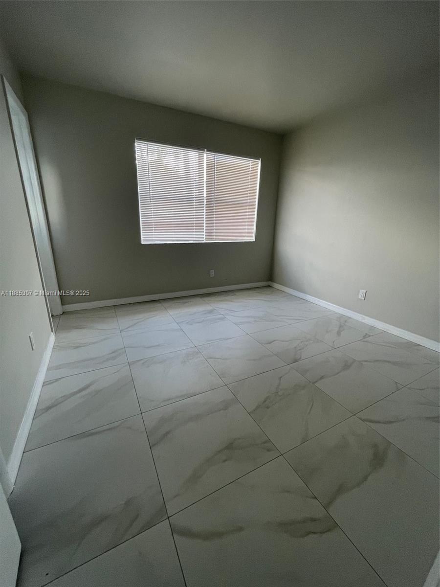 1102 South K Street, Unit 8 Lake Worth, FL 33460 - Photo 3 of 4 an empty room with a window