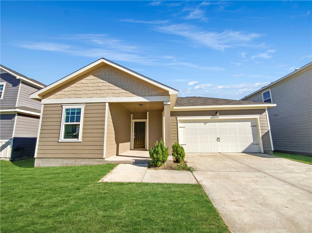 301 Seneca Loop Kyle, TX 78640 - Photo 1 of 1 a front view of a house with a yard and garage