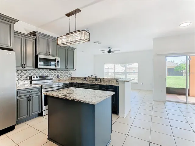 a kitchen with stainless steel appliances a refrigerator sink and microwave