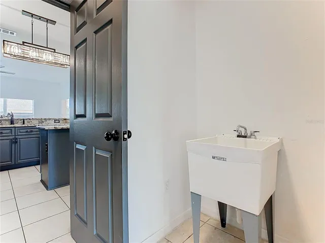 a view of wooden floor and a chandelier fan in a room