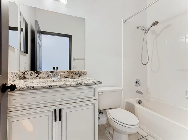 a view of bathroom with a toilet sink and mirror