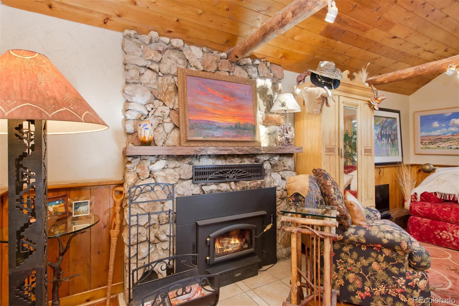 3010 Kerr Gulch Road Evergreen, CO 80439 - Photo 17 of 32 a living room with furniture and a fireplace