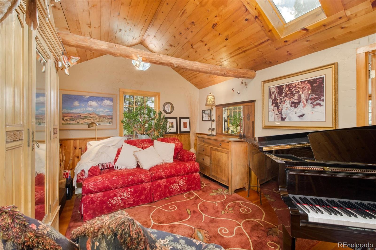 3010 Kerr Gulch Road Evergreen, CO 80439 - Photo 18 of 32 a bed room with a bed and a painting on the wall