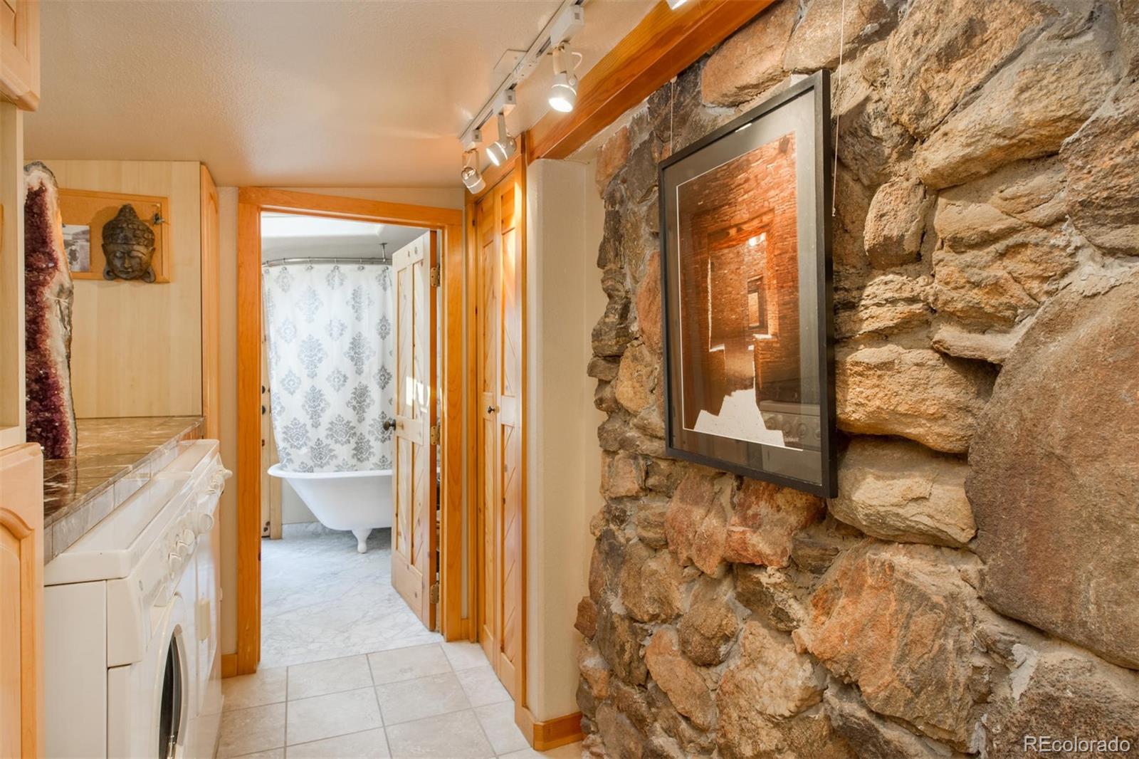 3010 Kerr Gulch Road Evergreen, CO 80439 - Photo 24 of 32 a bathroom with a granite countertop sink and mirror