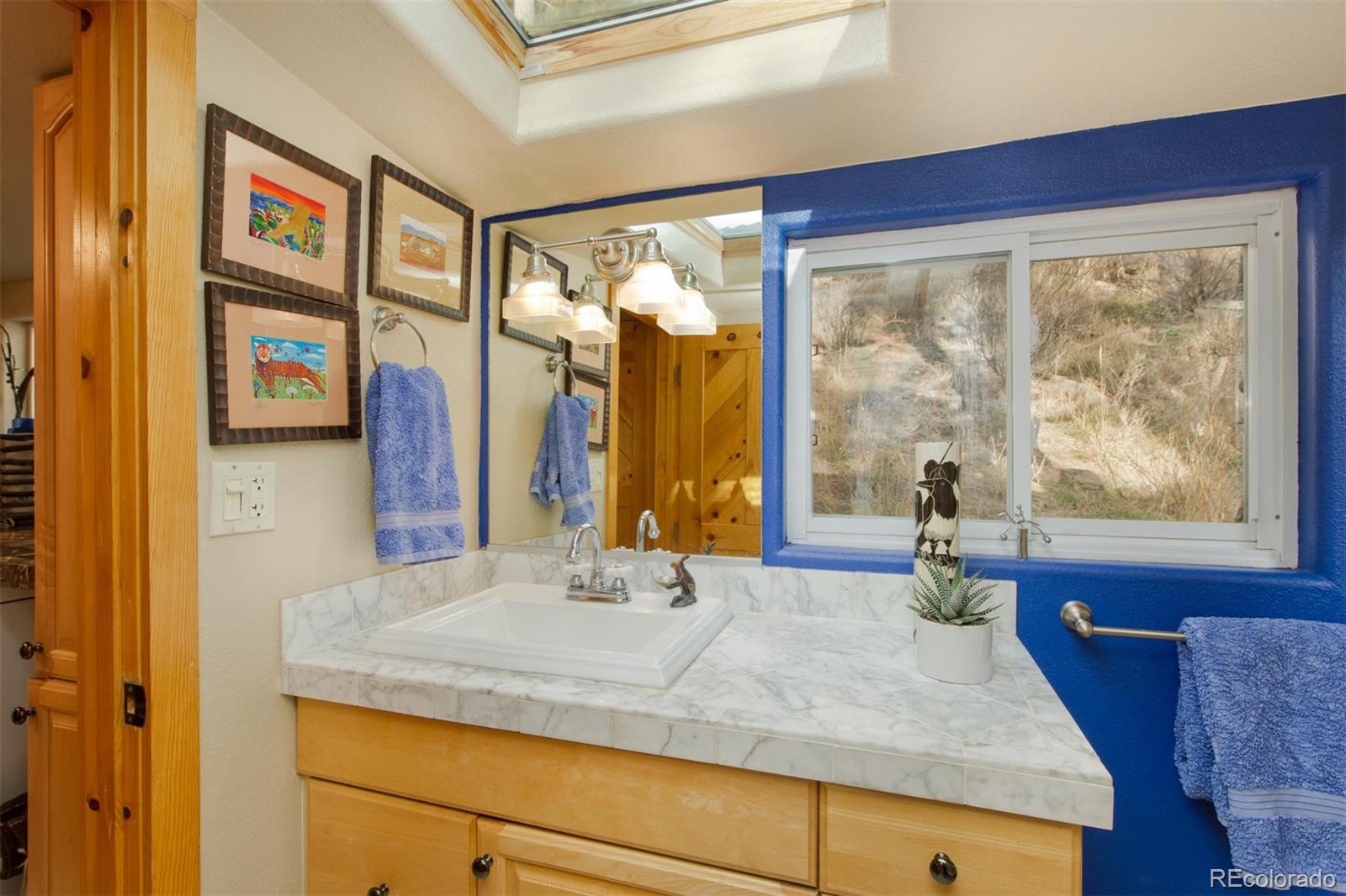 3010 Kerr Gulch Road Evergreen, CO 80439 - Photo 27 of 32 a bathroom with a tub and a large window