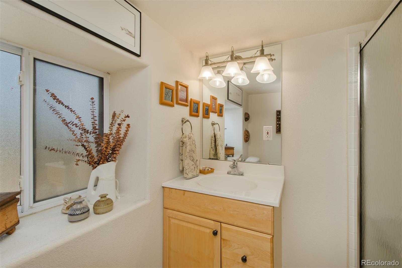 3010 Kerr Gulch Road Evergreen, CO 80439 - Photo 29 of 32 a bathroom with a sink and a mirror