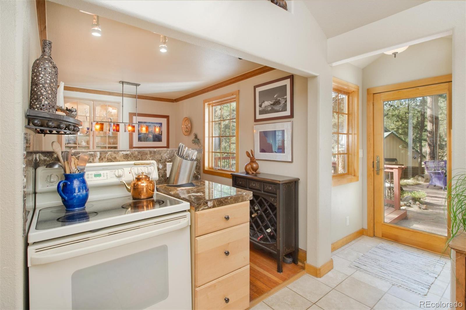 3010 Kerr Gulch Road Evergreen, CO 80439 - Photo 8 of 32 a kitchen with a refrigerator and a stove