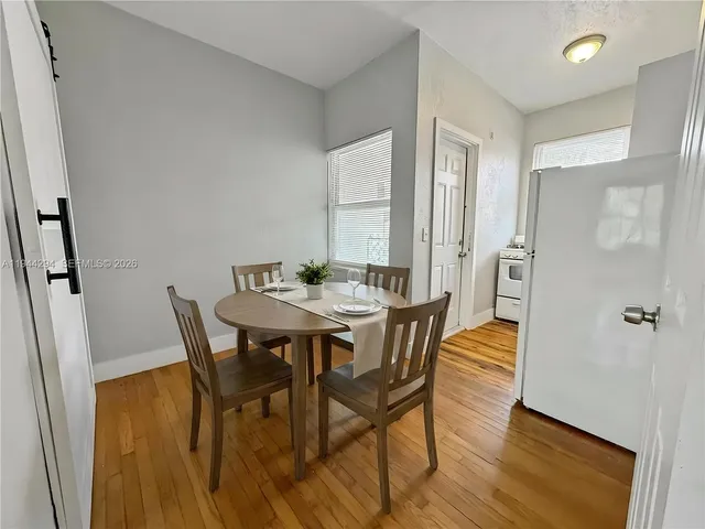 a view of a dining room with furniture and wooden floor
