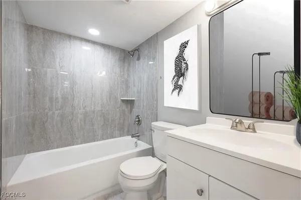 a bathroom with a sink toilet bathtub and vanity