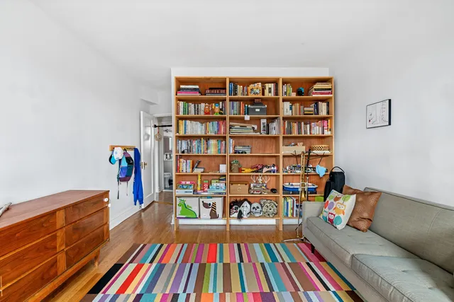 a reading room with furniture and book shelf
